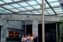 Wedding party (bride, bridesmaids, family member) posing outside Kilkenny Ormonde Hotel entrance