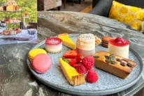 Assorted cakes, macarons and fresh berries on a plate in a hotel lounge, family afternoon tea setting