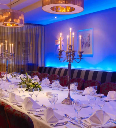 Elegant family dinner setup in a hotel private dining room with candlelit centrepiece