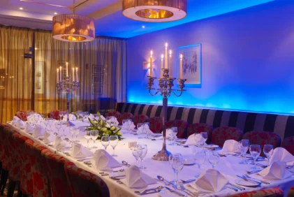 Elegant family dinner setup in a hotel private dining room with candlelit centrepiece