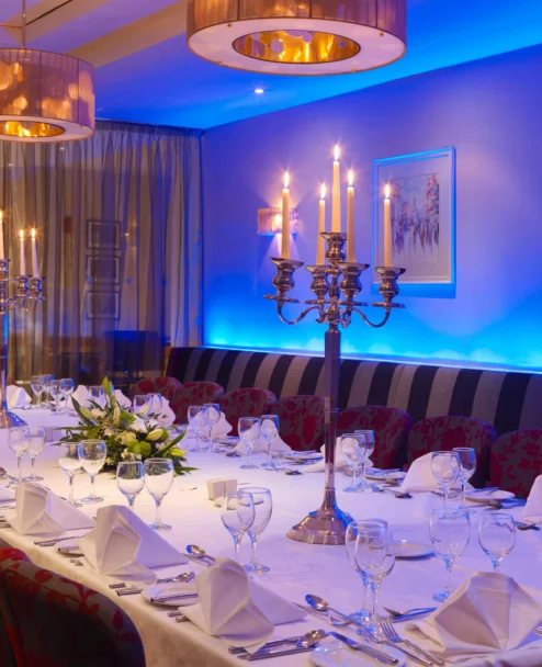 Elegant family dinner setup in a hotel private dining room with candlelit centrepiece